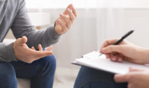 Photo of a young male in a counseling session with a family therapist. Our therapists offer counseling and mental health therapy to individuals in the Philadelphia area.